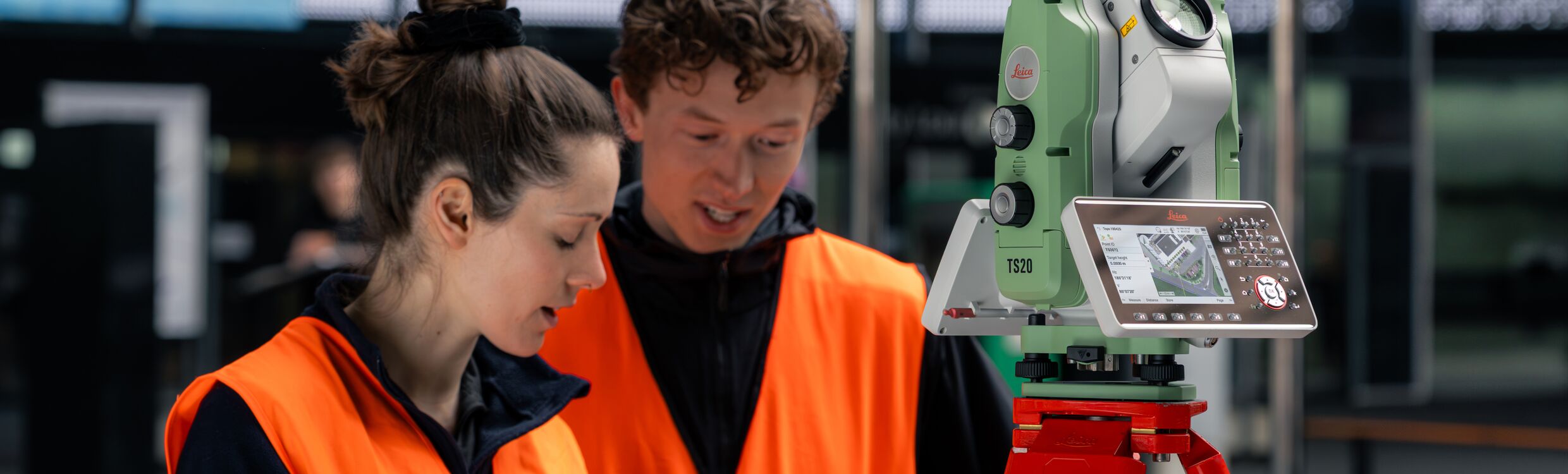 Survey professionals using a custom‑made application to control and capture data from a Leica TS20 robotic total station, demonstrating software integration with Leica Geosystems surveying instruments.